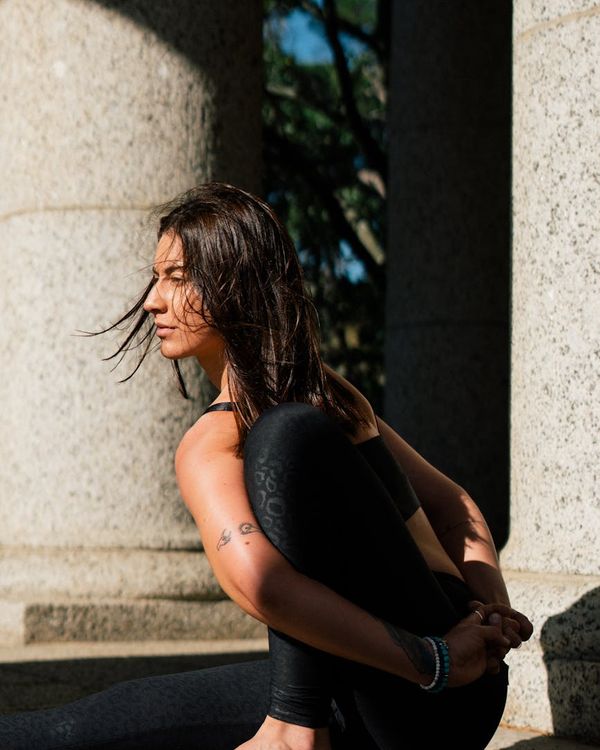 Person meditating calmly in a comfortable cross-legged position.